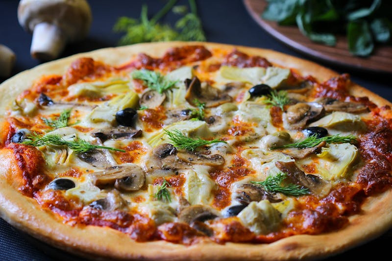 Truffle Mushroom gourmet pizza with white truffle oil drizzle